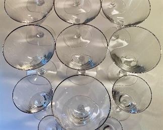 Lot 6191. $40.00. Ten Fostoria clear stems w/silver rim for champagne or sorbet (5.5"t) with 2 larger cordial (5.25"t) and 5 small cordials