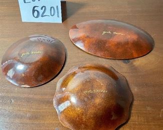 Lot 6201. $90.00. A trio of mid-century enamel on copper pieces from Gerte Hacker. They are all signed and have a pebble tray. Scalloped green: 5.5"dia, yellow dish: 5.25"dia, and oval: 7.5"x4.5"