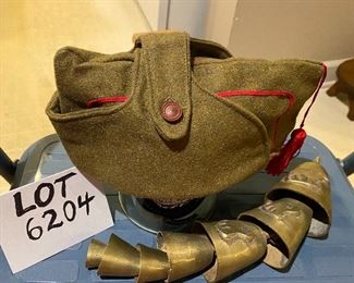 Lot 6204. $25.00 Youth or Man's Hat, vintage with button over top in a military khaki green with red trim and tassel, and set of Brass Bells, (7) in staggered sizes and sounds - hang in door opening. Vintage.
