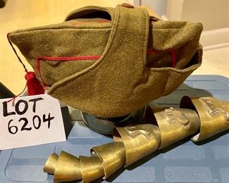 Lot 6204. $25.00 Youth or Man's Hat, vintage with button over top in a military khaki green with red trim and tassel, and set of Brass Bells, (7) in staggered sizes and sounds - hang in door opening. Vintage.