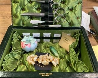 Kirby Beard & Co Ltd. Antique Sewing Box with all the fixings. Pin Cushion, Thimble, Needles, Key and package. Set in tufted satin lined display box. You've never seen anything like it.