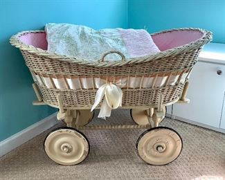 $80 Vintage wicker bassinet on wheels. Baby blanket is included.