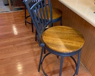 $320 Set of 4 wood and metal swivel bar chairs measuring 17.75d at the base, 16d seat and 40 h.