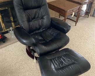 Set of 2 black, leather swivel chairs by Lane with matching ottomans. Measures 34”W x 34”D x 38”H