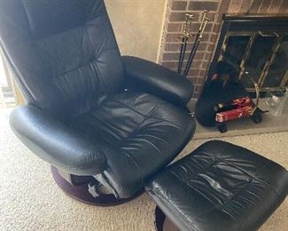 Set of 2 black, leather swivel chairs by Lane with matching ottomans. Measures 34”W x 34”D x 38”H