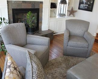 Pair of modern swivel club chairs.