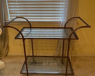 Mid-century glass and metal bar cart on casters