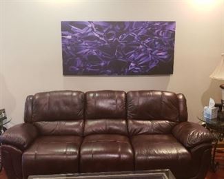 Dark brown leather sofa, side tables, lamps, canvas art