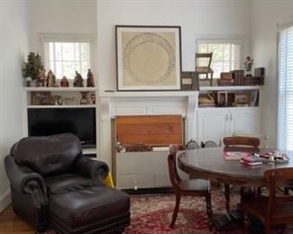 GREAT HAVERTY'S LEATHER CHAIR AND OTTOMAN. SWEET RESTYLED VINTAGE TRUNK IN GREY. ANTIQUE BOOKS AND VERY NICE LARGE RUG.