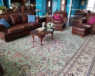 Another view of the living room furniture and a large beautiful rug