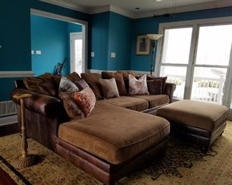 Leather/cloth upholstered sofa with lounger and ottoman