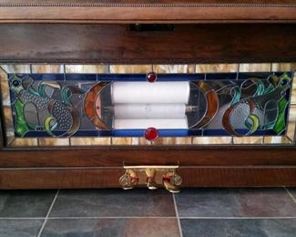 A closer look at the lower stained glass panel.  Inside is the piano roll, two drums, and a cymbal