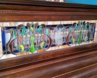 A closer look at the upper stained glass panel.  Inside is a set of bells and a tambourine.