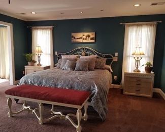 Waterbed with wrought iron headboard, beautiful padded bench, and two Henredon nightstands