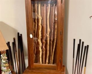 gun cabinet, wooden shaft golf clubs, walking sticks