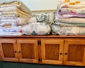 lots of quilts, handmade oak storage cabinet