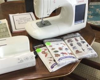 Singer machine with embroidery capabilities.  Many patterns, attachments, etc