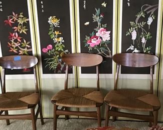 Six wooden chairs with rush seats in front of hand embroidered 8 panel Oriental screen depicting seasons.  This was a gift to the doctor and his wife from a patient.