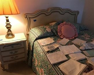 Many linens on French style double bed