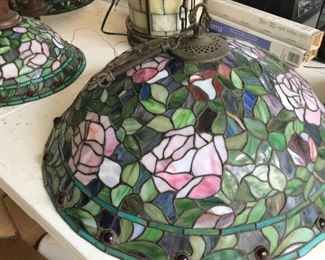 One of four Tiffany style lamps three hanging and one floor lamp