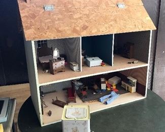 Three floored doll house.  Roof folds up to reveal third floor. Hand made.
