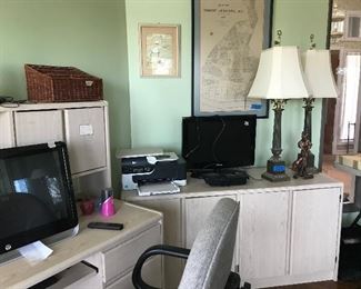 Computer desk and various office items.