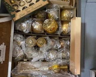 Lot#804 $75 - 2 Shiny Brite boxes of gold ornaments and 2 tree toppers