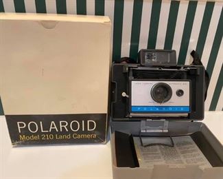 Polaroid Automatic Land Camera Model 210 
We do not know if it works.
You can bring batteries to check.