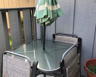 Outside glass top table w/umbrella and 3 folding chairs