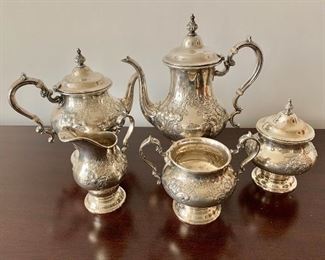 $2250 -  Five-piece sterling silver set. Coffee pot 11"H x 9 1/2"W x 5 1/2"D. Teapot 9'H x 10"W x 5 1/2"D. Creamer 5 1/2"H x 5"W x 3 1/4"D. Large handled urn/sugar bowl 6"H x 4 1/2" diameter. Sugar bowl 5"H x 7"W x 4" diameter. 