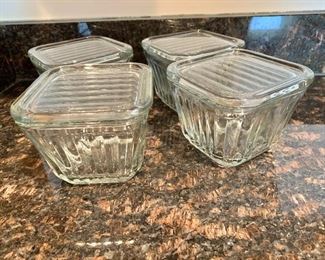 $40 - Set of four vintage glass refrigerator storage containers with lids; 3 1/2" H x 4" square 