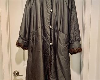 $160;  Raincoat with removable fur lining and leather tie belt.  Leather piping detail.  Falls midway at calf; Medium