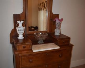 Eastlake Style Victorian Dresser with Cheval style Mirror and Marble Top  Adorned with Gorgeous Fenton White Opalescent Coin Dot double handled vase and Hand painted Satin Glass Vase with Ruffled Cranberry Glass Edging at the top. ( both Vases Circa 1940's - 50's)