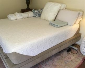 Full view of king bed with base - rug under bed