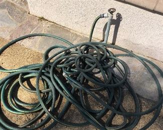 lots of gardening equipment and hoses