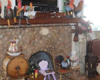 Fireplace with, roosters, wooden train and carriage, childs antique rocking chair, antique butter churn, Limoges pitcher and bowl sets.