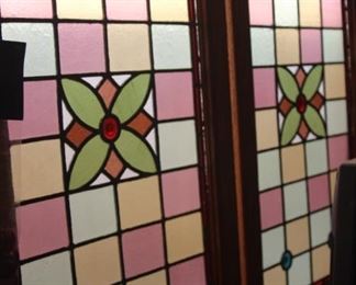 Two antique stained glass window panels.