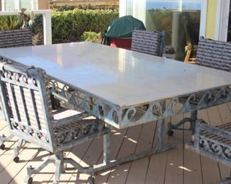 Very large sheet metal custom patio table with wave theme design all around the edge, 6 rolling patio chairs all custom made.