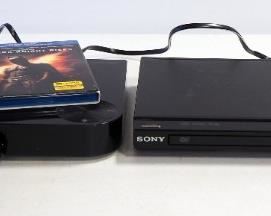 Samsung Bluray Disk Player Model 80-E5400 And Sony CD/DVD Player Model DVP-SR500H, Both With Remotes, Both Power On, And Dark Night Rises DVD