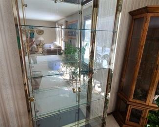 Brass and glass curio/display cabinet. Glass shelves. Beautiful condition. 75" tall x 32" wide x 14" deep. Asking $300.