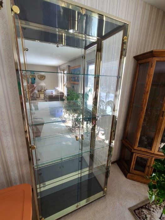 Brass and glass curio/display cabinet. Glass shelves. Beautiful condition. 75" tall x 32" wide x 14" deep. Asking $300.