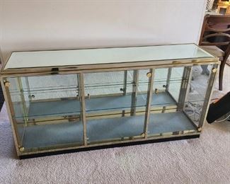 Brass and glass credenza/display cabinet. Beautiful condition. 60" wide x  29" tall x 16" deep. Asking $200.