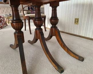 1940's Duncan Phyfe style 3-pedestal, drop-leaf dining table and two chairs. Drop leaves work well. Comes with three additional 12" leaves. Chairs have been reupholstered. Asking $400 for the set.