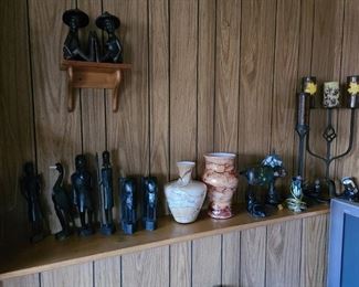 Various African statues and figurines, misc. vases and stained glass lamps. Various prices.