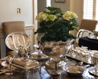 Beautiful assortment of sterling and plated silver on round dining table