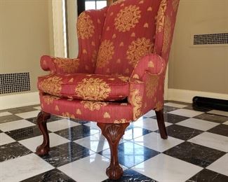 Red upholstered chair with gold detail - 45" high x 38" wide x 30" deep