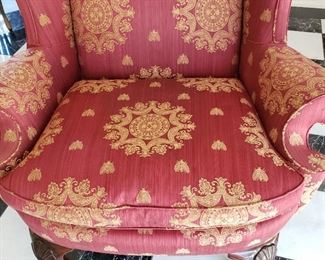 Red upholstered chair with gold detail - 45" high x 38" wide x 30" deep