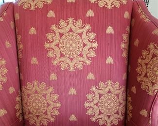 Red upholstered chair with gold detail - 45" high x 38" wide x 30" deep