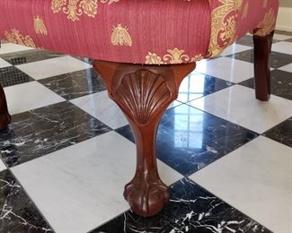 Red upholstered chair with gold detail - 45" high x 38" wide x 30" deep