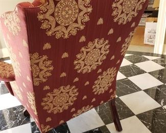 Red upholstered chair with gold detail - 45" high x 38" wide x 30" deep